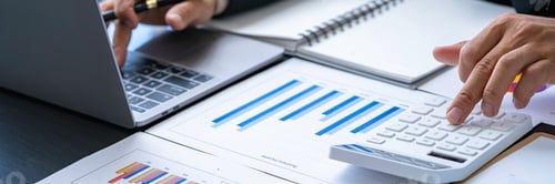 Preview: Businessman discussing analysis charts or graphs on desk table and using a laptop computer. Close up