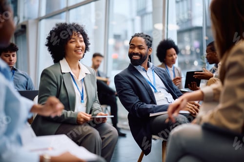 Vista previa: Happy black entrepreneur and his coworkers attending a business seminar in board room.
