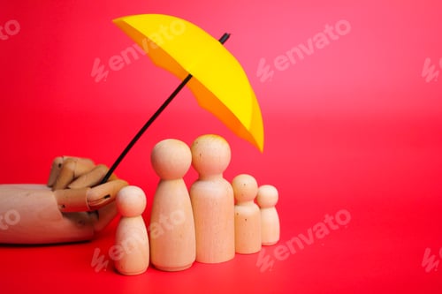 Preview: a family of wooden figures protected by a yellow umbrella