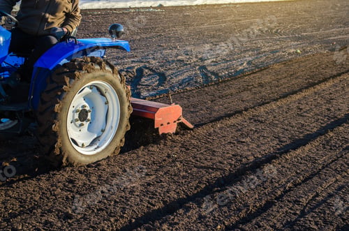 Preview: A farmer on a tractor cultivates a farm field.