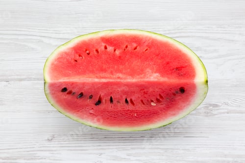 Preview: Fresh cut watermelon on a white wooden background, view from above.
