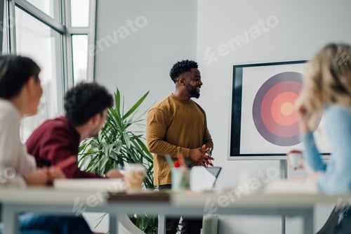 Preview: Business professional presenting at team meeting