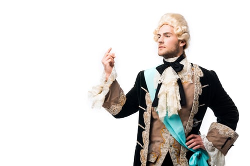 Preview: pompous victorian gentleman in wig standing with hand on hip and gesturing isolated on white