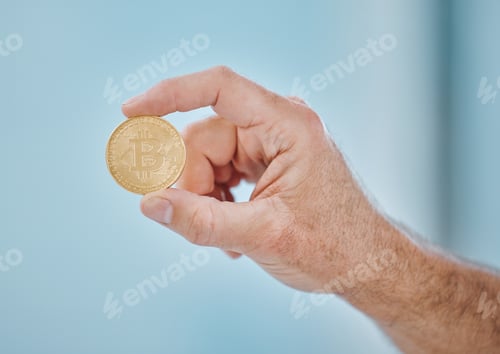 Preview: Cropped shot of an unrecognisable businessman holding a bitcoin in the office