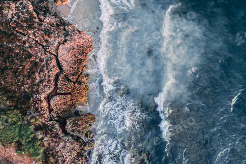 Preview: Drone shot of heavy waves crashing rocky cliffs