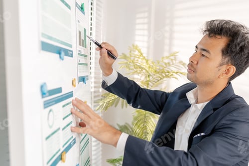 Preview: A businessman preparing a marketing and financial plan in a modern office