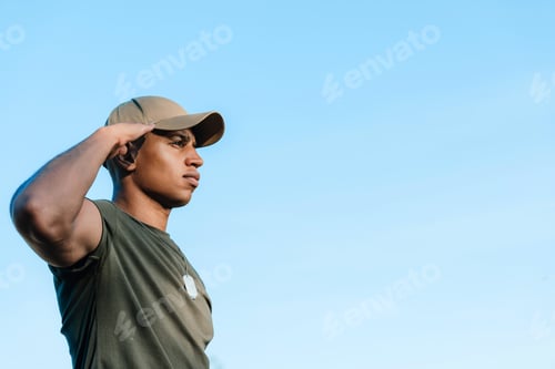 Preview: side view of african american soldier in cap with tag dog against blue sky