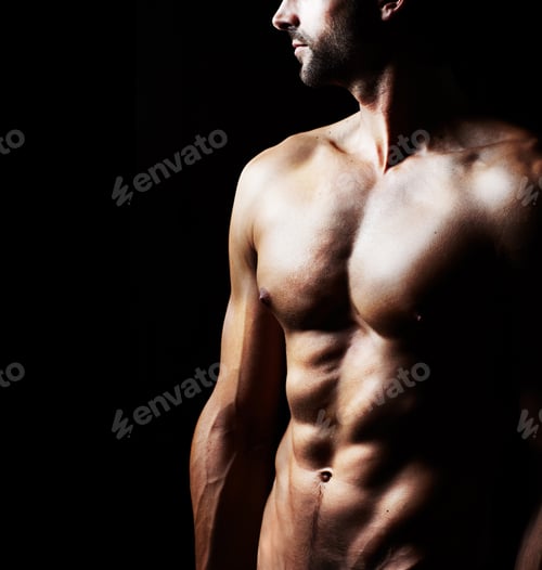 Preview: Masculinity in portrait. Studio shot of a muscular shirtless man isolated on black.