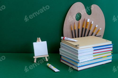 Preview: Colorful school supplies on a green background