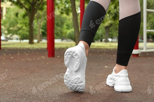 Preview: Woman in comfortable stylish sneakers outdoors, closeup