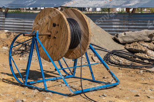 Preview: Wooden Coils Of Electric Cable Outdoor. High and low voltage cables in storage