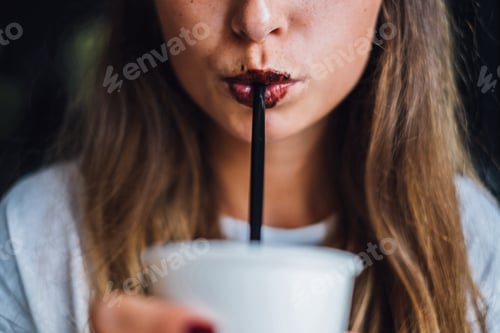 Preview: Woman with chocolate lips drinking coffee