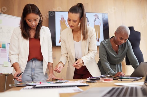 Preview: Designers with a dream. Shot of a group of female designers working in an office.