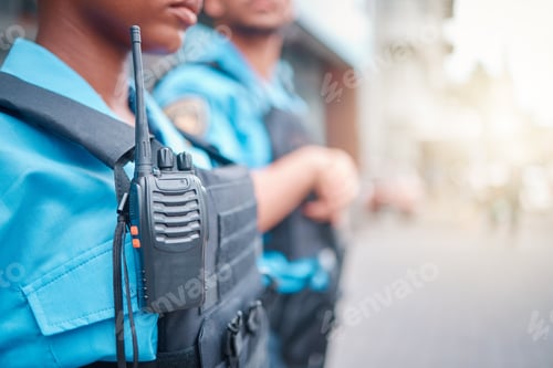 Preview: Radio, police and surveillance with a black woman officer standing outside while on patrol in the c