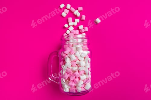 Preview: marshmallows on a pink background. top view