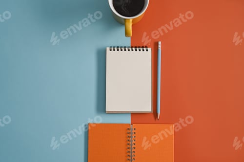 Preview: Flat lay notepad, pencil and coffee cup on colorful background.