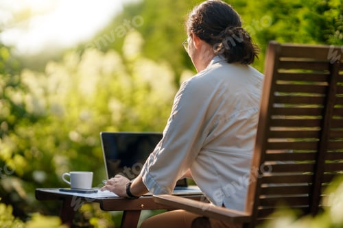 Preview: woman working on laptop in summer morning