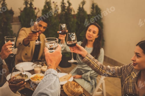 Preview: Family and friends celebrating at dinner on a rooftop terrace