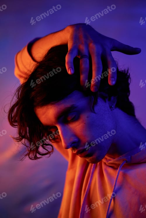 Preview: Handsome Young Man in Blue and Orange Neon Light