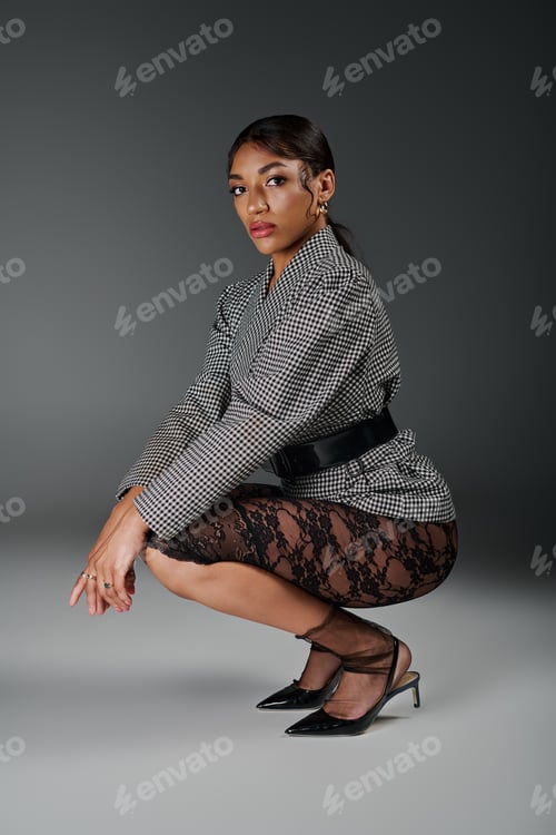 Preview: Stylish young African American woman in smart casual attire posing confidently