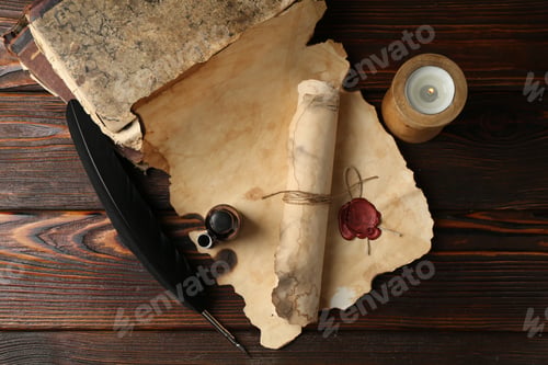 Preview: Paper scrolls, burning candle, feather, inkwell and books on wooden table, flat lay