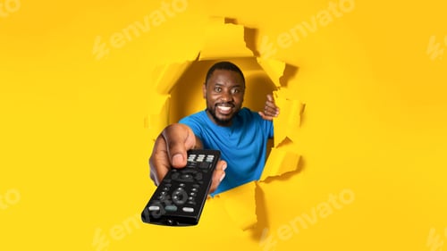 Preview: Television programming advertisement. Black man pointing television remote controller, posing in