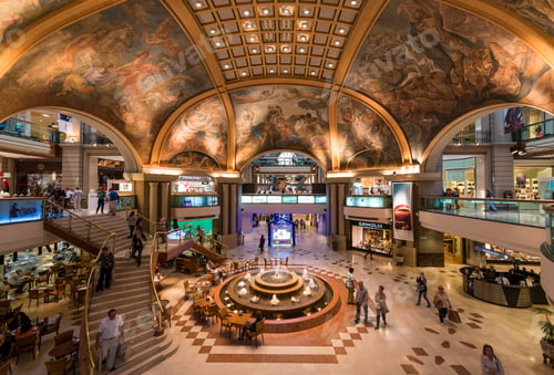 Preview: Shoppers wandering in an opulent mall with a grandiose ceiling mural.