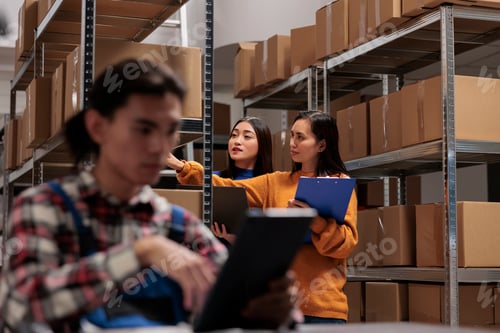 Preview: Delivery manager taking package to prepare order for shipping