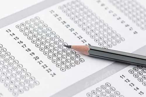 Preview: Student marks answers on a multiple choice test using a pencil on a printed answer sheet