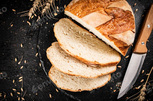 Preview: Sliced on a stone board wheat bread with grains.