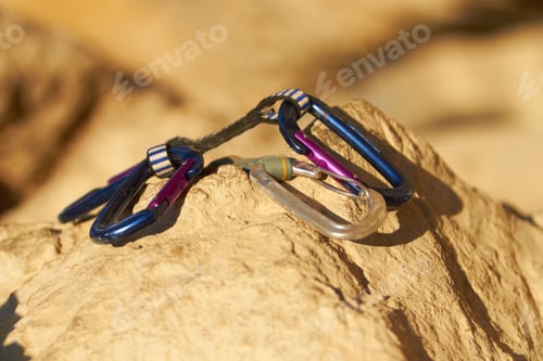 Preview: The climbers best friend. Carabiners lying on a rock.