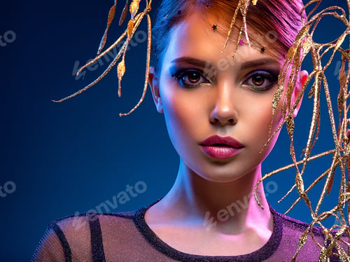 Preview: Stylish fashion model with a golden decoration around her face.