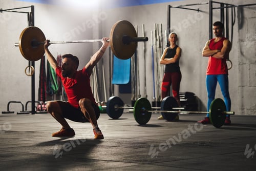 Preview: Man squatting and lifting a barbell.