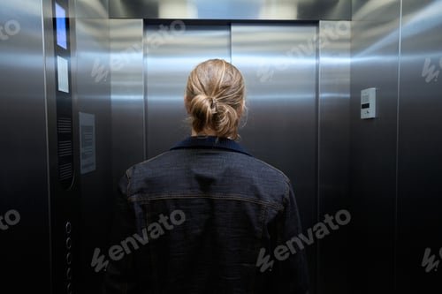 Preview: Male in a denim jacket is in passenger elevator cabin