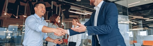 Preview: colleagues are shaking their hands in modern office during teamwork meeting
