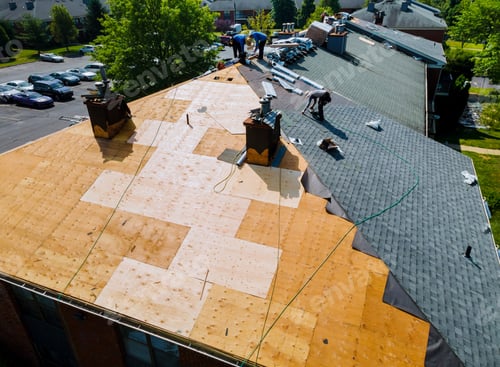Preview: Roof repairs old roof replacement with new shingles of an apartment building