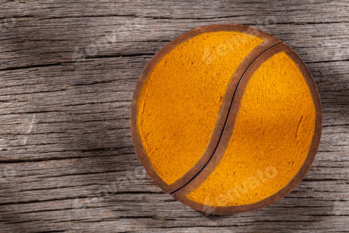 Preview: Turmeric powder in bowl on wooden background