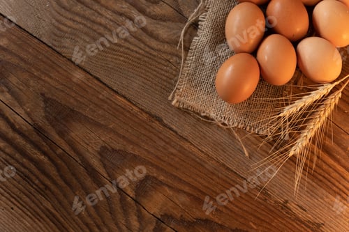 Preview: Brown eggs on a burlap on an old wooden table