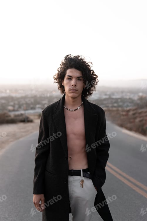 Preview: A shirtless young man wearing a gabardine is posing during the sunset in Baldwin Hills, Los Angeles