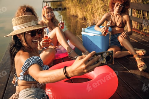 Preview: Group of female friends enjoying a summer day at the lake.