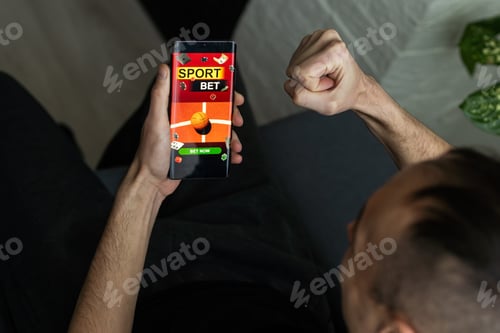 Preview: Man watching football play online broadcast on his laptop, cheering for his favourite team, making