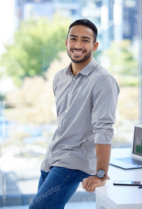 Preview: Portrait of a confident young businessman standing in an office