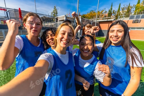 Preview: Happy women soccer team celebrating victory taking selfie
