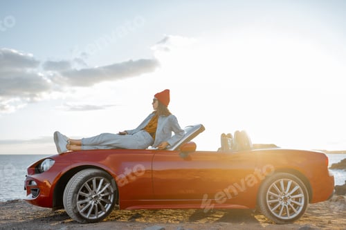 Preview: Woman traveling by car on the rocky coastline