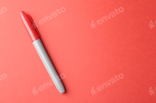Preview: One color marker on red background, top view. Space for text