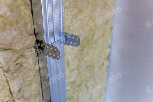 Preview: Wall of a room under renovation with mineral rock wool insulation and metal frame