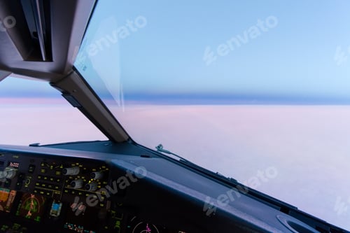 Preview: Beautiful twilight sunset sky at high altitude from airplane cockpit view.