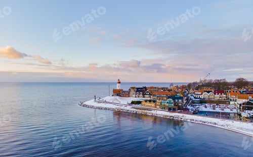 Preview: Lighthouse of Urk during winter with snow in the Netherlands. Dutch old village