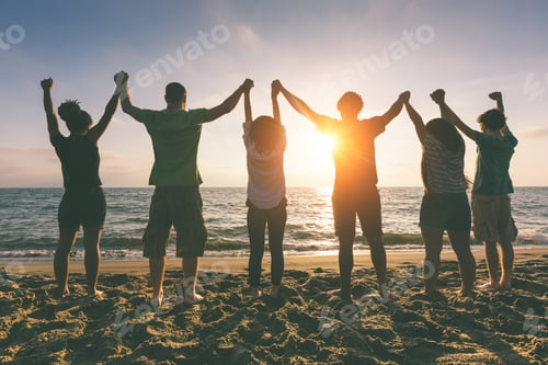Preview: Multiracial group of people with raised arms looking at sunset