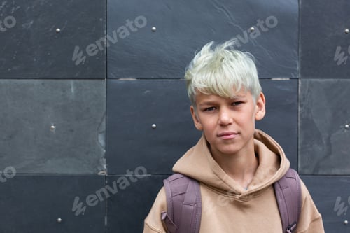 Preview: Portrait of handsome Teenager on the city street, outdoors